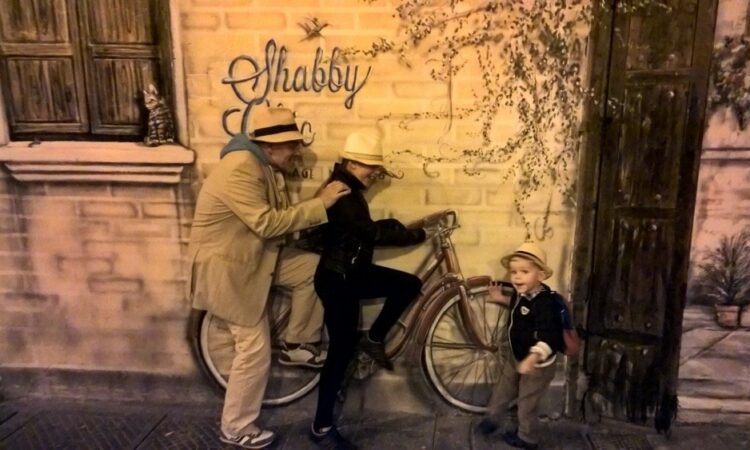 Image of adult, mural, young girl and boy